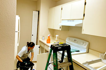 Cabinet cleaning inside and out during move-out cleaning.