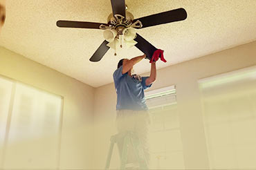 Ceiling fan cleaning during a move-out cleaning project in Orlando."