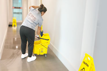 Our employee expertly mops the office tile floor, ensuring a spotless and inviting workspace.